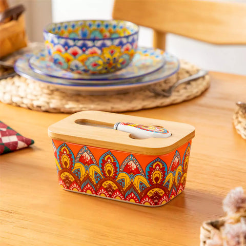 Lumi bold orange porcelain butter dish with lid in vibrant Bohemian pattern on a wooden table
