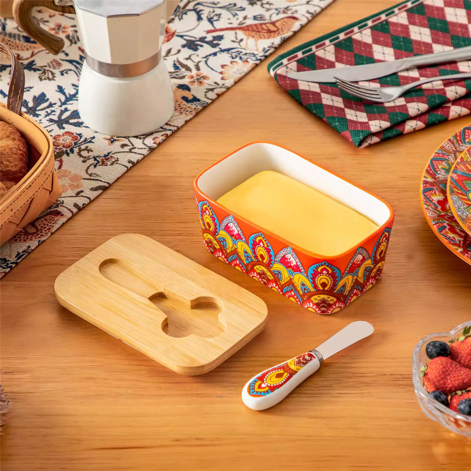 Lumi bold orange porcelain butter dish with lid in vibrant Bohemian pattern on a wooden table