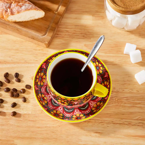 Lumi 6 piece 9oz porcelain coffee cup and saucer set with vibrant  pattern Bohemian design on a rustic wooden table