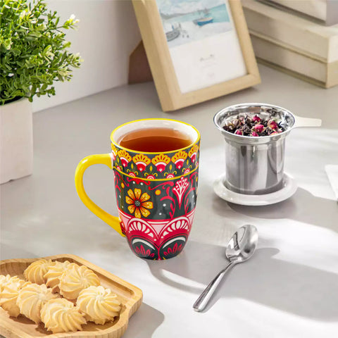 Lumi lemon yellow porcelain tea mug with infuser and lid featuring vibrant Bohemian pattern on a wooden desk with laptop and plant