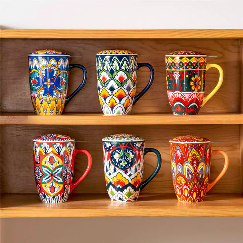 Lumi lemon yellow porcelain tea mug with infuser and lid featuring vibrant Bohemian pattern on a wooden desk with laptop and plant