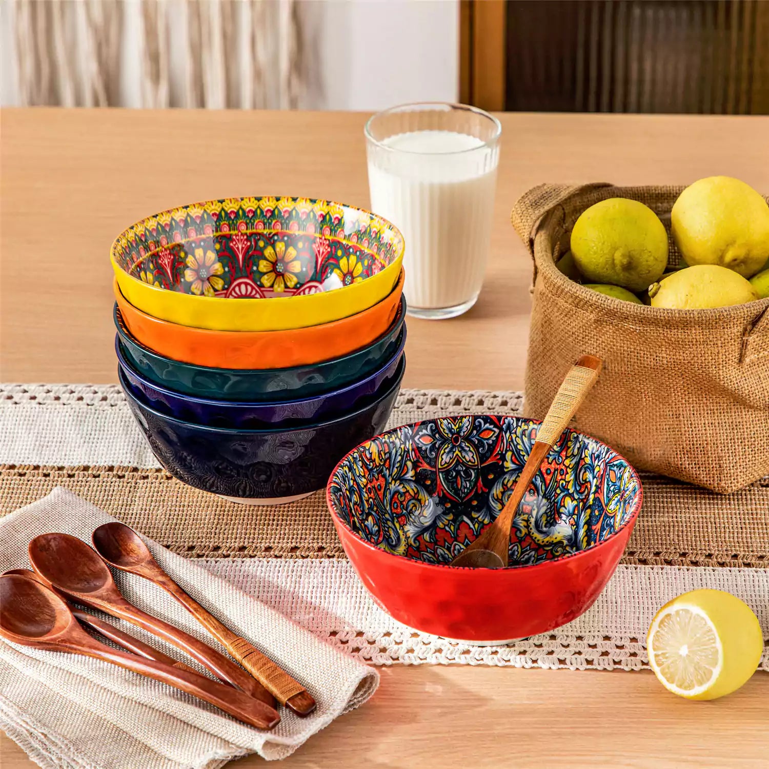 Colorful 26oz Lumi porcelain bowls on rattan placemats filled with oatmeal berries roasted broccoli and cherries on a linen table runner