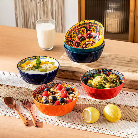 Colorful 26oz Lumi porcelain bowls on rattan placemats filled with oatmeal berries roasted broccoli and cherries on a linen table runner