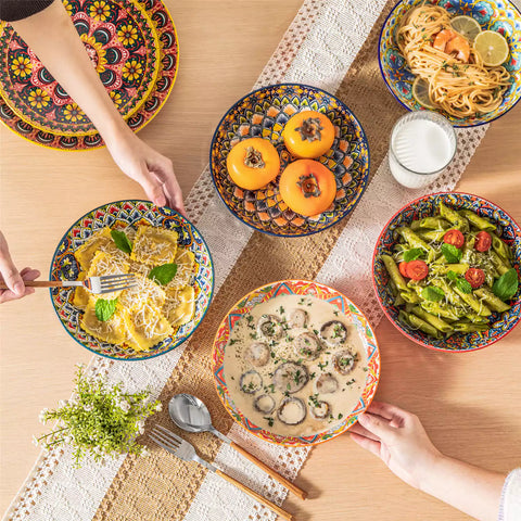 Vibrant Boho pasta bowls on a wooden table filled with pasta cherries and persimmons for a colorful, casual dining setting