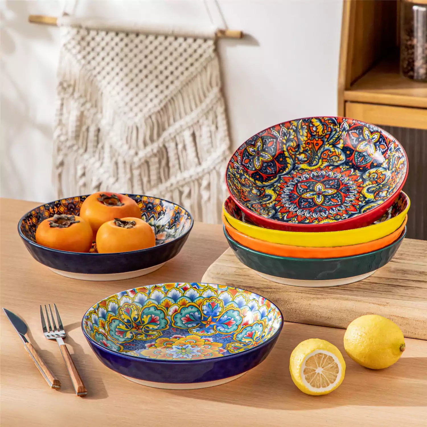 Vibrant Boho pasta bowls on a wooden table filled with pasta cherries and persimmons for a colorful, casual dining setting