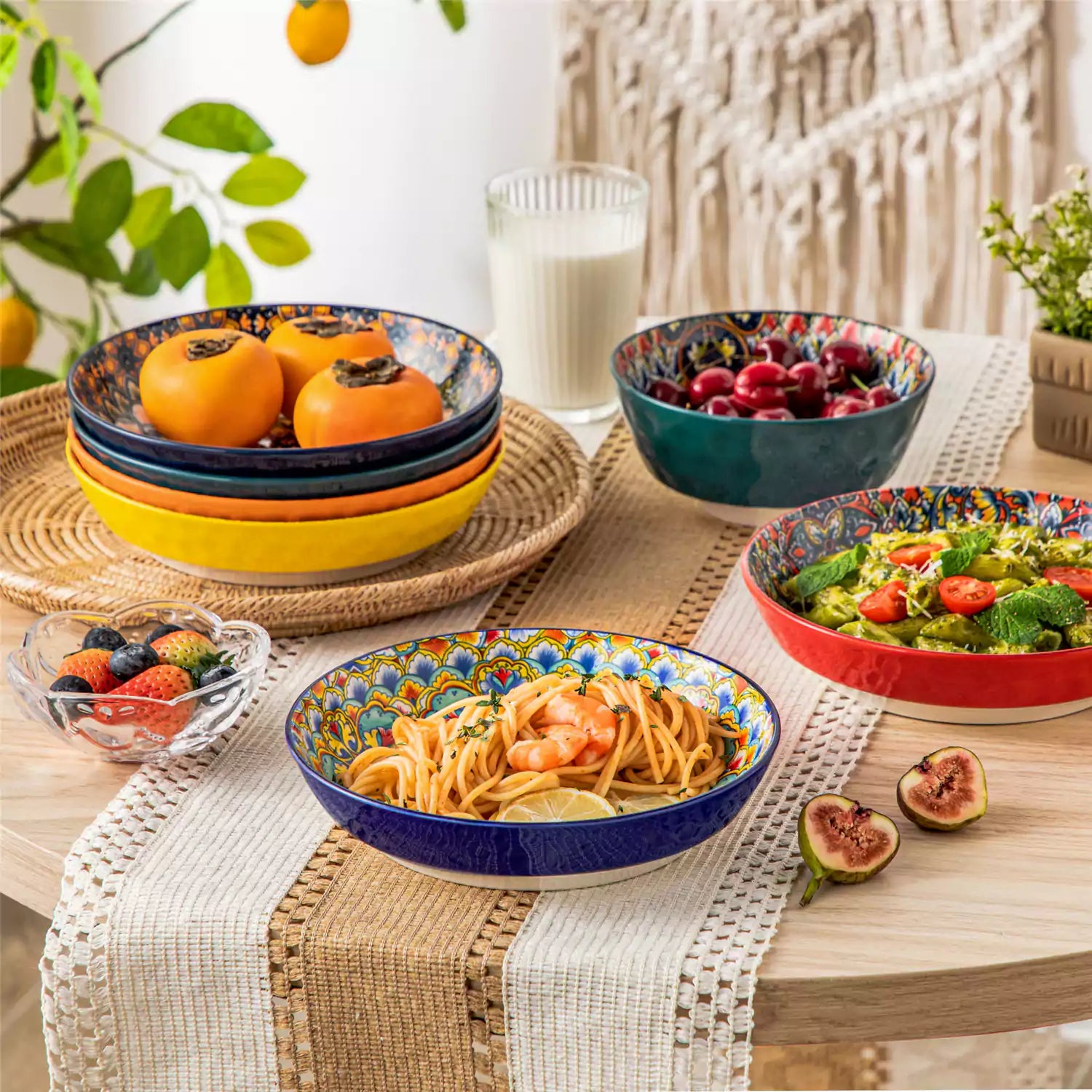 Vibrant Boho pasta bowls on a wooden table filled with pasta cherries and persimmons for a colorful, casual dining setting