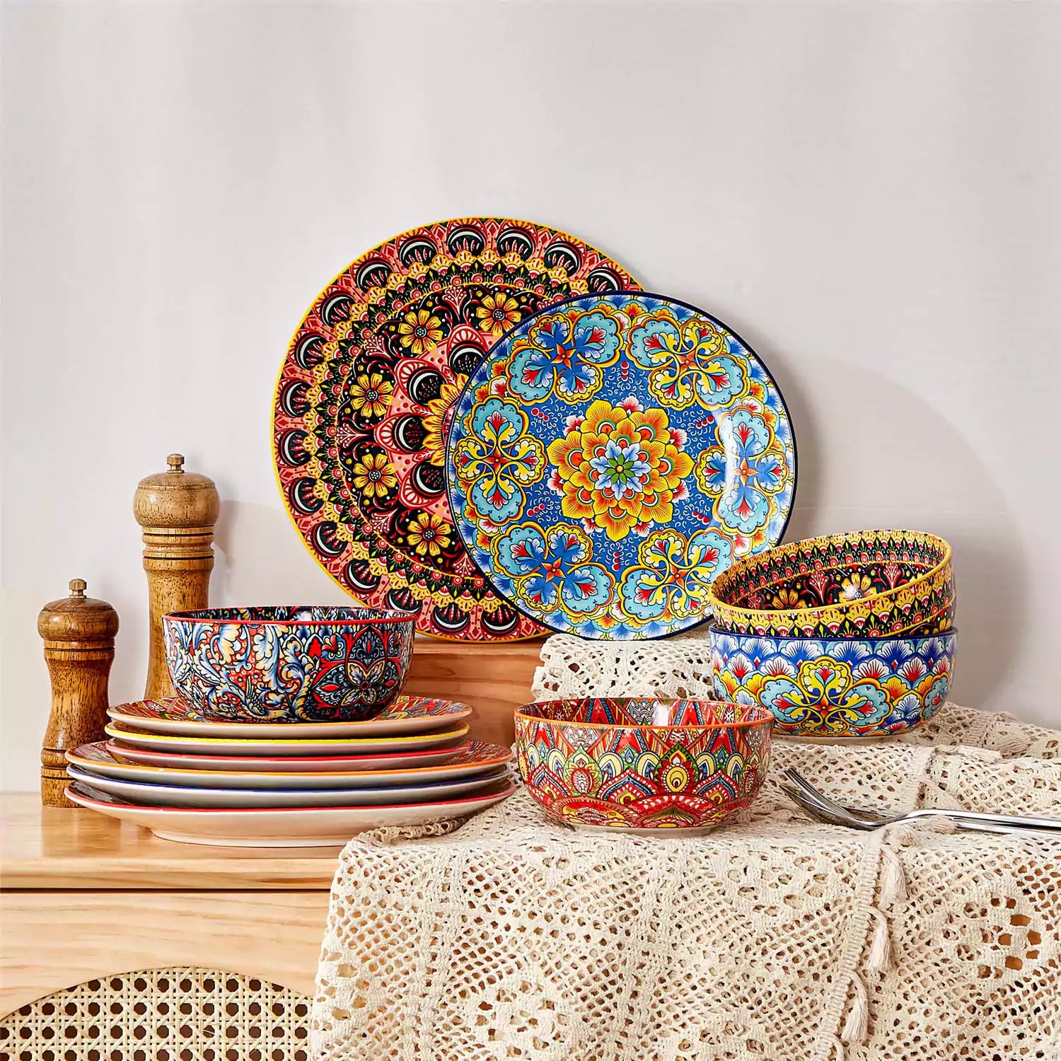 Lumi 12-piece Bohemian dinnerware set for 4 with colorful patterned plates and bowls on a wooden Boho dining table with food