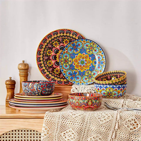 Lumi 12-piece Bohemian dinnerware set for 4 with colorful patterned plates and bowls on a wooden Boho dining table with food