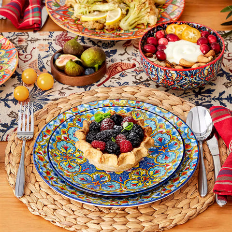 Lumi 12-piece Bohemian dinnerware set for 4 with colorful patterned plates and bowls on a wooden Boho dining table with food