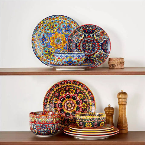 Lumi 12-piece Bohemian dinnerware set for 4 with colorful patterned plates and bowls on a wooden Boho dining table with food