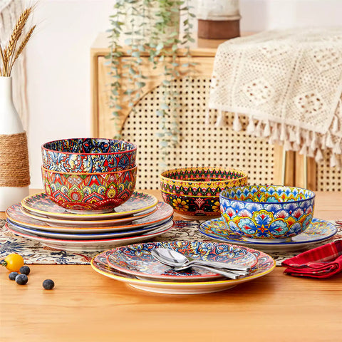 Lumi 12-piece Bohemian dinnerware set for 4 with colorful patterned plates and bowls on a wooden Boho dining table with food