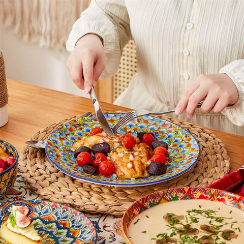 Bohemian style dining table set with Lumi 24 piece colorful dinnerware bowls and vibrant table décor ready for a lively meal