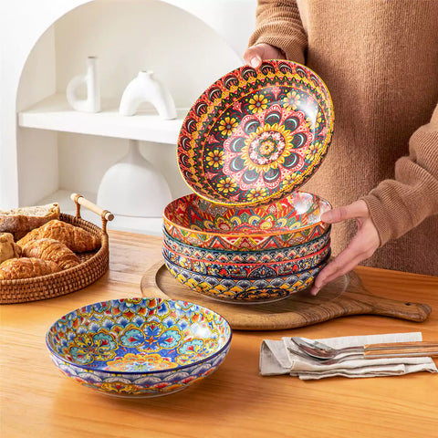 Vibrant Lumi porcelain pasta bowls filled with fruit salad pumpkin soup and pasta on a wooden dining table