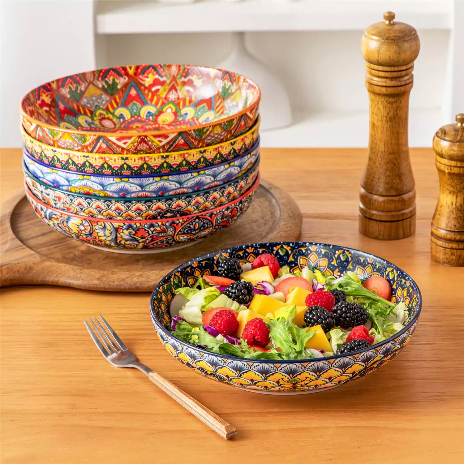 Vibrant Lumi porcelain pasta bowls filled with fruit salad pumpkin soup and pasta on a wooden dining table