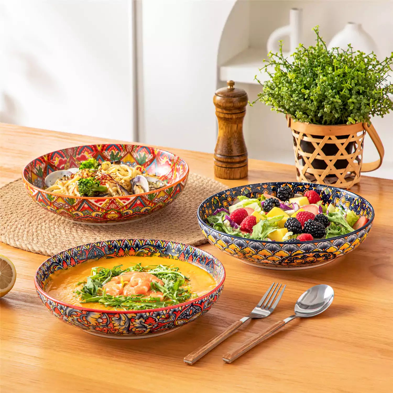 Vibrant Lumi porcelain pasta bowls filled with fruit salad pumpkin soup and pasta on a wooden dining table