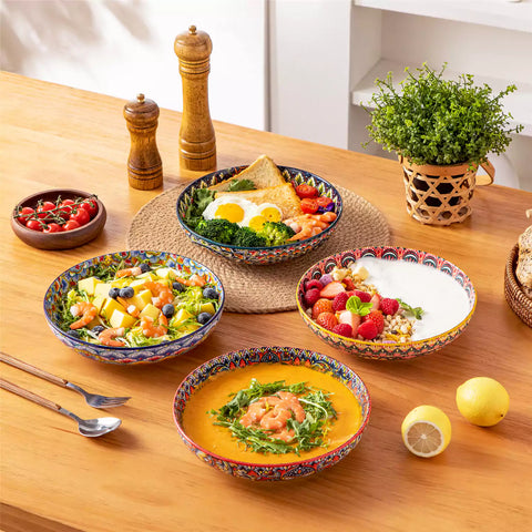 Vibrant Lumi porcelain pasta bowls filled with fruit salad pumpkin soup and pasta on a wooden dining table