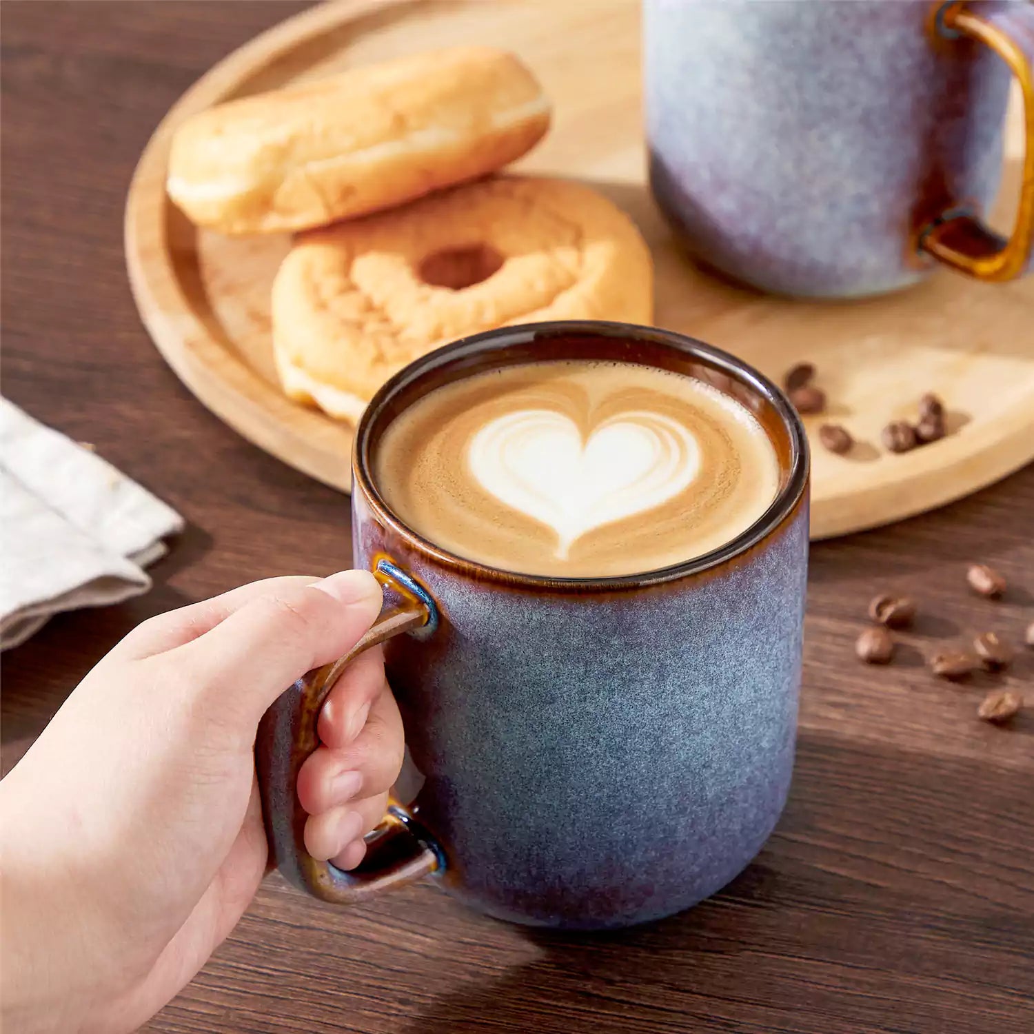Cup of coffee with latte art cookies and coffee beans on a wooden table featuring onion mugs set of 4 in 16oz