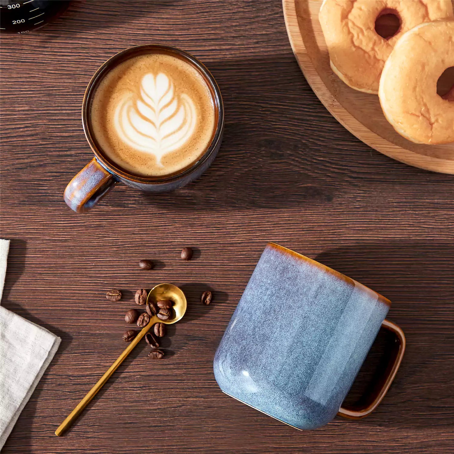 Cup of coffee with latte art cookies and coffee beans on a wooden table featuring onion mugs set of 4 in 16oz