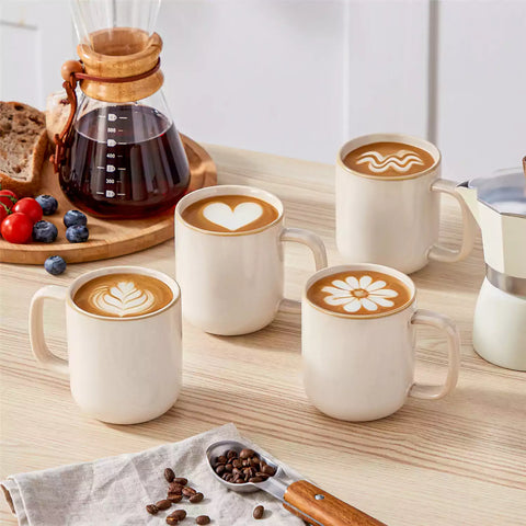 Playa 12oz stoneware mugs in glossy beige reactive glaze on a rustic wooden table for a cozy breakfast with fresh coffee pastries and berries