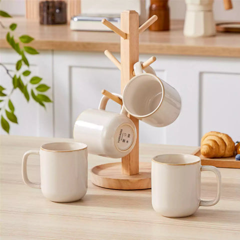 Playa 12oz stoneware mugs in glossy beige reactive glaze on a rustic wooden table for a cozy breakfast with fresh coffee pastries and berries