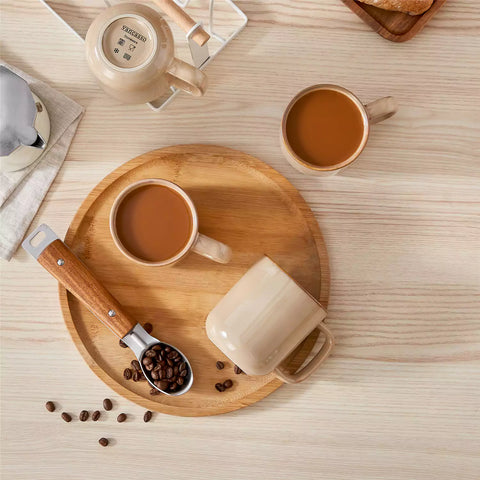Playa 12oz stoneware mugs in glossy brown reactive glaze on a rustic wooden table for a cozy breakfast with fresh coffee pastries and berries