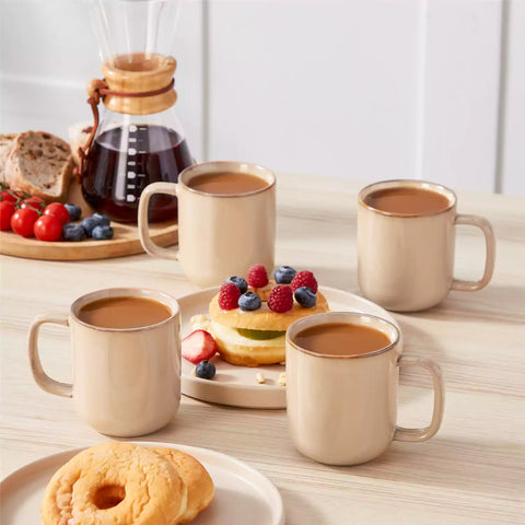 Playa 12oz stoneware mugs in glossy brown reactive glaze on a rustic wooden table for a cozy breakfast with fresh coffee pastries and berries