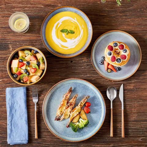 A glossy deep indigo 16-piece stoneware dinnerware set from the Playa collection - featuring farmhouse charm with plates and bowls for 4 people-vancasso