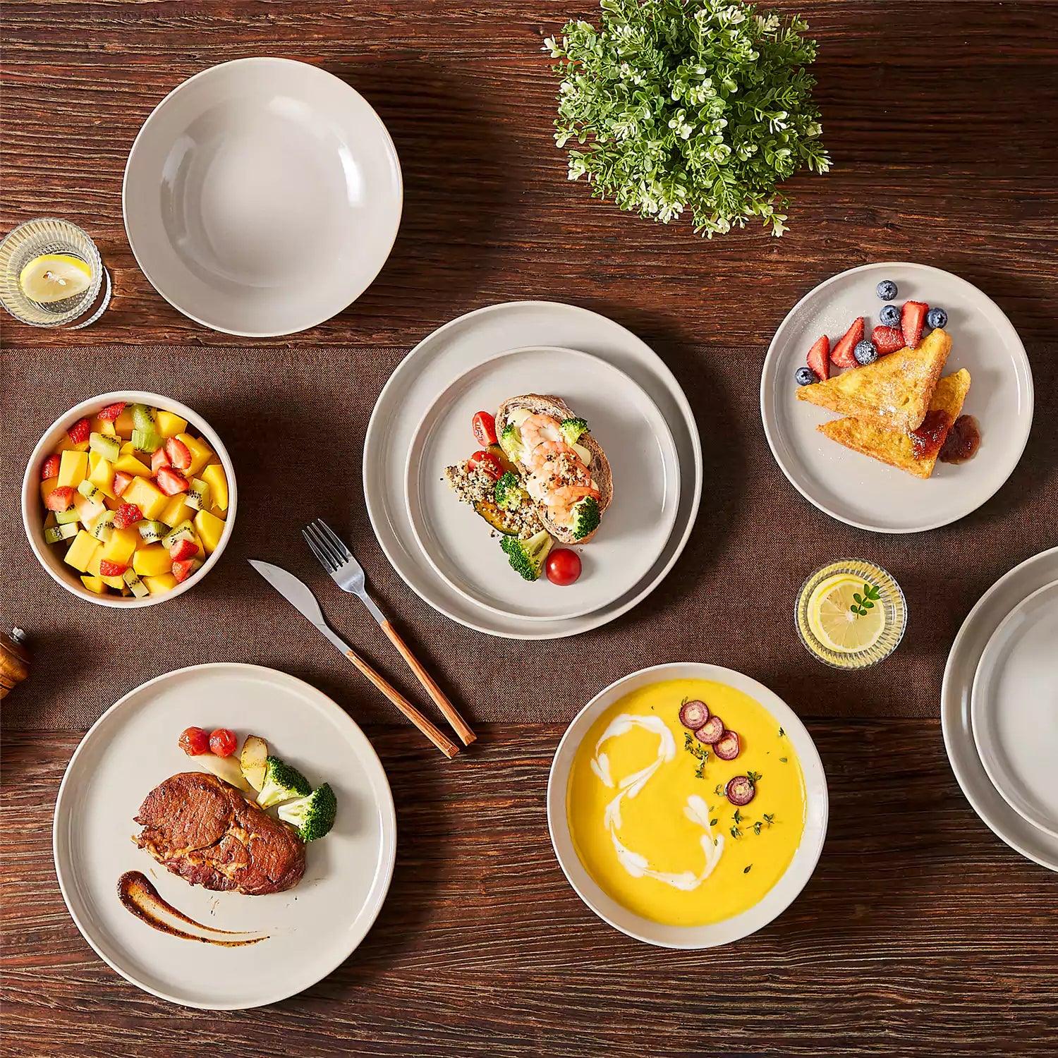 A glossy grey 16-piece stoneware dinnerware set from the Playa collection - featuring farmhouse charm with plates and bowls for 4 people-vancasso