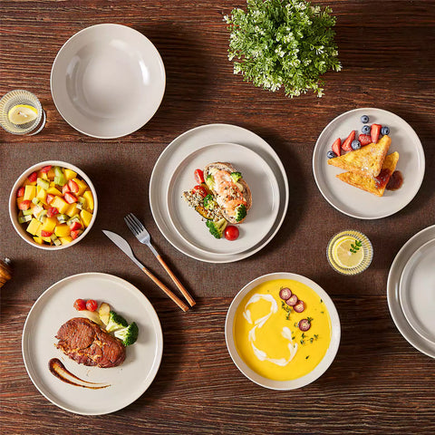A glossy grey 16-piece stoneware dinnerware set from the Playa collection - featuring farmhouse charm with plates and bowls for 4 people-vancasso
