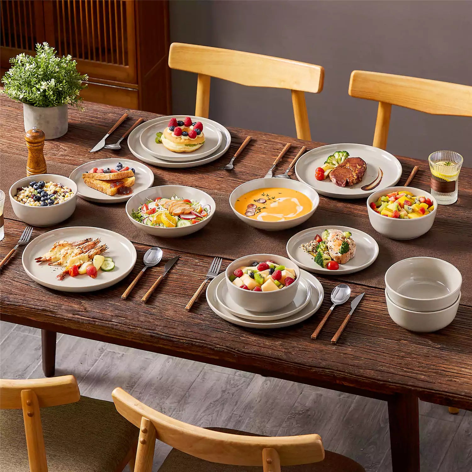 A glossy grey 16-piece stoneware dinnerware set from the Playa collection - featuring farmhouse charm with plates and bowls for 4 people-vancasso