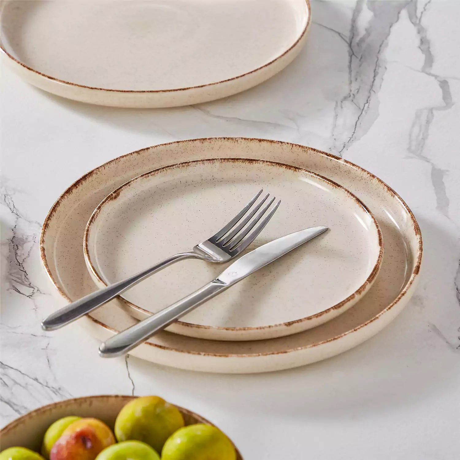 Plays 18-piece stoneware dinnerware set with steak and vegetables on marble table - featuring sandy speckled plates and bowls with brown rims-vancasso