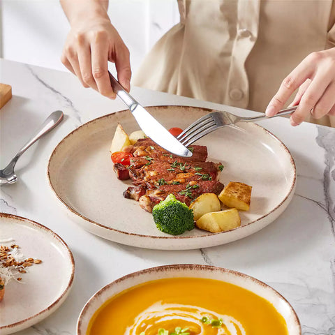 Plays 24-piece stoneware dinnerware set with pasta - soup - and fruit waffle on marble table - featuring sandy speckled plates and bowls with brown rims-vancasso