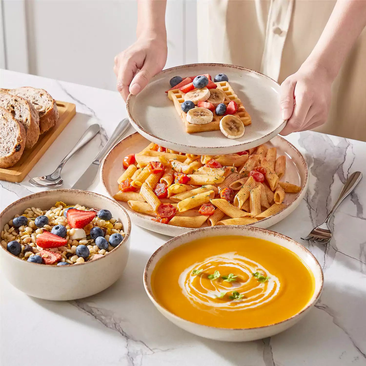 Plays 24-piece stoneware dinnerware set with pasta - soup - and fruit waffle on marble table - featuring sandy speckled plates and bowls with brown rims-vancasso