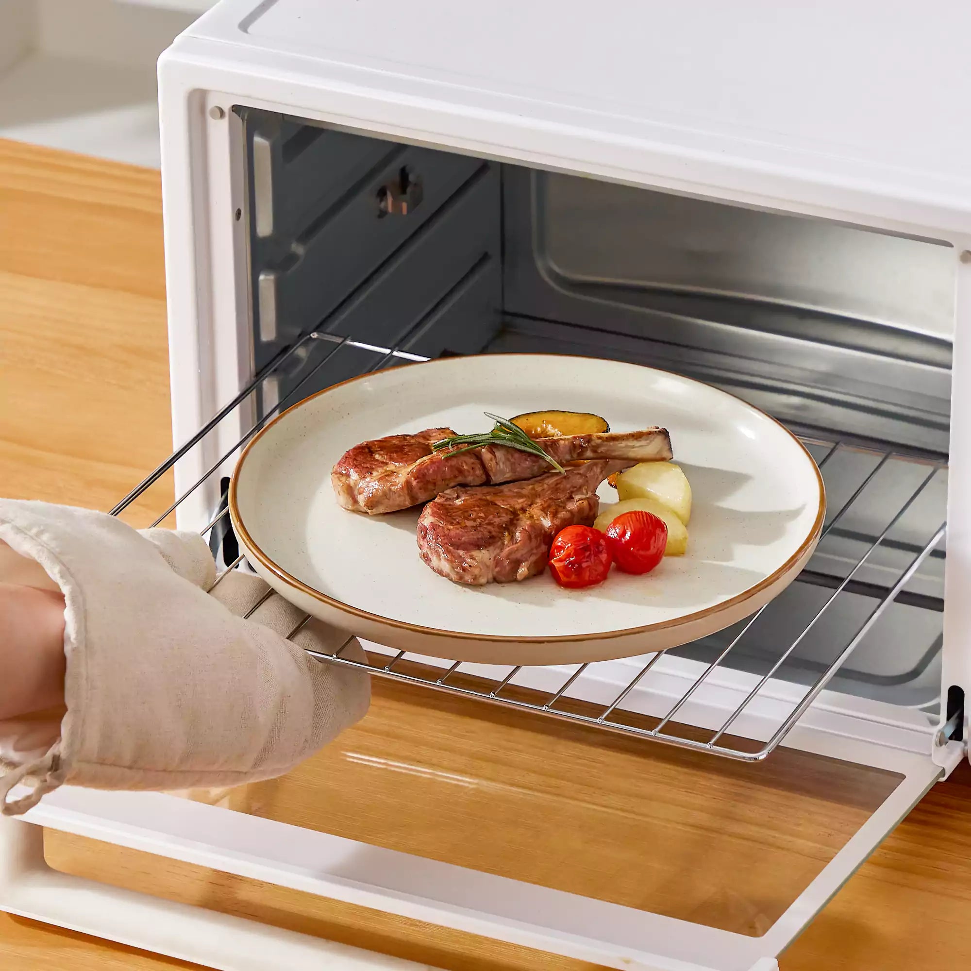 Beige rustic stoneware dinnerware set with speckled - lipped-edge plates and bowls on a dining table with flowers and cutlery in a cozy modern kitchen-vancasso