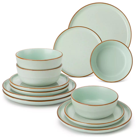 Green rustic stoneware dinnerware set with speckled - lipped-edge plates and bowls on a dining table with flowers and cutlery in a cozy modern kitchen-vancasso