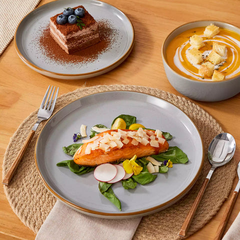 Grey rustic stoneware dinnerware set with speckled - lipped-edge plates and bowls on a dining table with flowers and cutlery in a cozy modern kitchen-vancasso