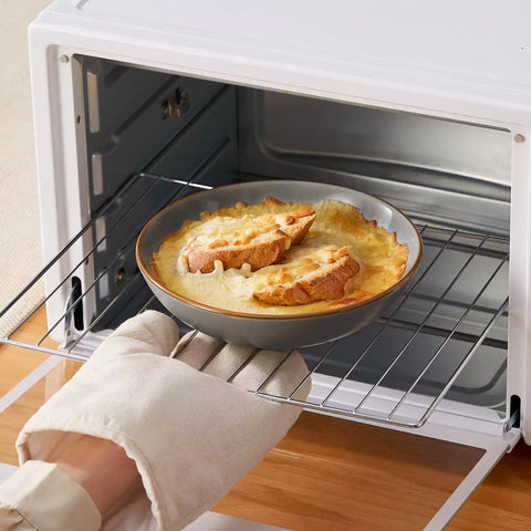 Rustic grey speckled stoneware dinnerware set with lipped-edge plates and bowls arranged on a sunlit modern dining table-vancasso
