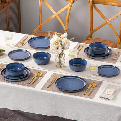 Sata blue stoneware 12 piece dinnerware set with dinner plates salad plates and cereal bowls styled with gold cutlery on textured surface farmhouse reactive glaze lipped edge service for 4