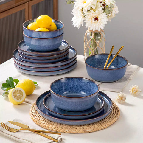 Sata blue stoneware 12 piece dinnerware set with dinner plates salad plates and cereal bowls styled with gold cutlery on textured surface farmhouse reactive glaze lipped edge service for 4