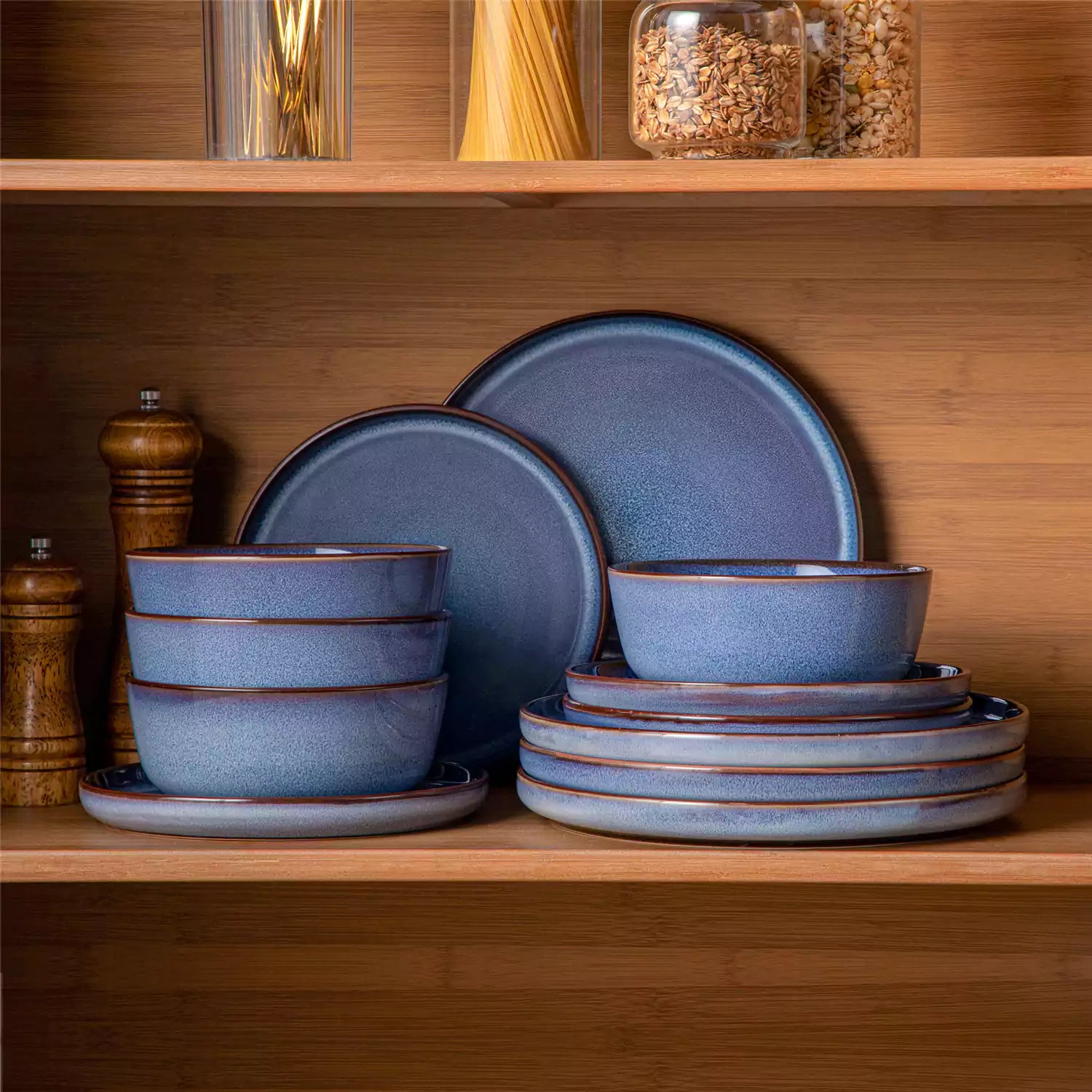 Sata blue stoneware 12 piece dinnerware set with dinner plates salad plates and cereal bowls styled with gold cutlery on textured surface farmhouse reactive glaze lipped edge service for 4