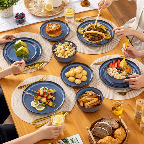 Sata blue stoneware 18 piece dinnerware set with dinner plates salad plates and cereal bowls styled on a wooden table with diverse meal setup farmhouse reactive glaze lipped edge service for 6