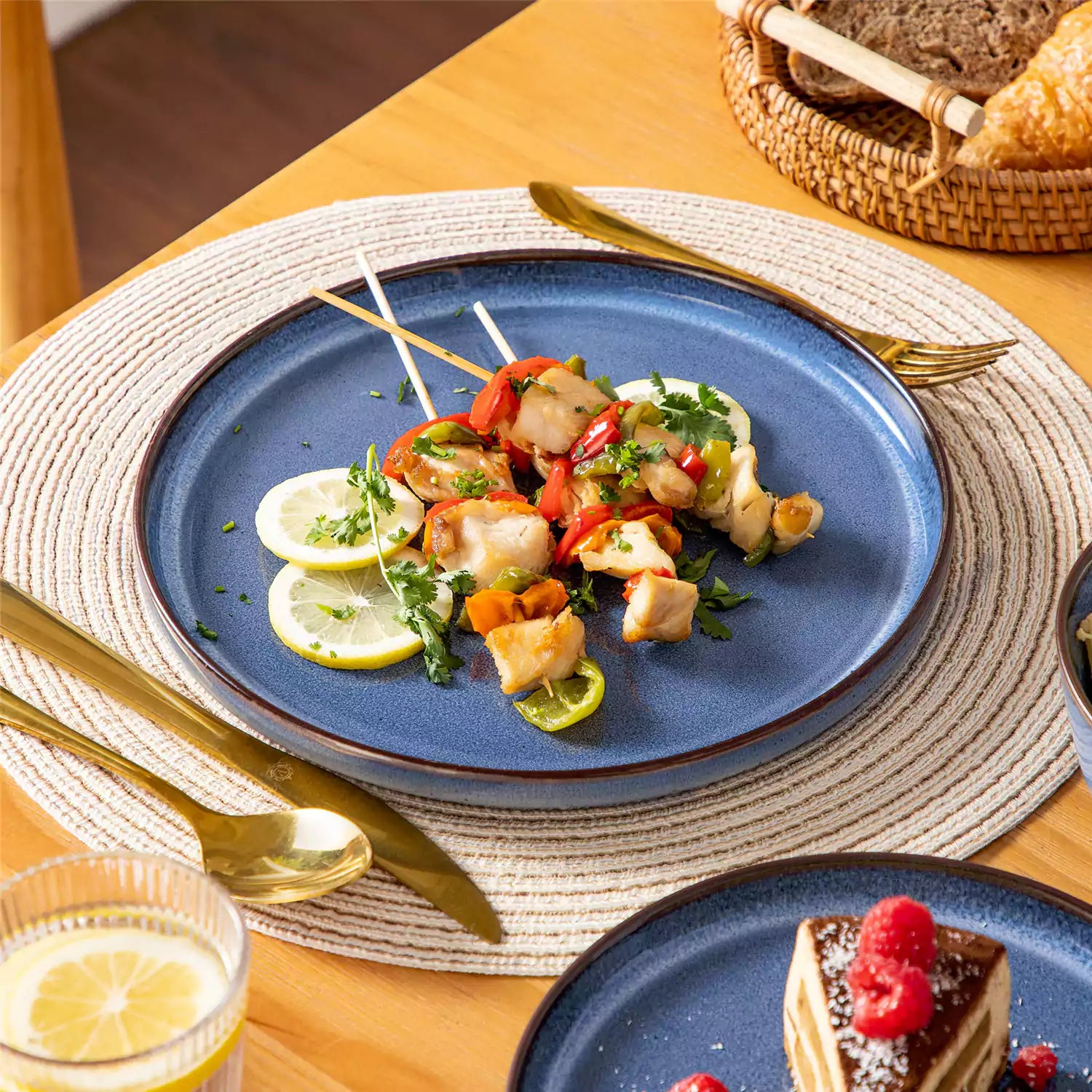 Sata blue stoneware 18 piece dinnerware set with dinner plates salad plates and cereal bowls styled on a wooden table with diverse meal setup farmhouse reactive glaze lipped edge service for 6