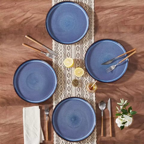 Sata blue stoneware dinner plate set of 4 styled with lamb chops and vegetables on a dinner table farmhouse lipped edge reactive glaze one of a kind finish