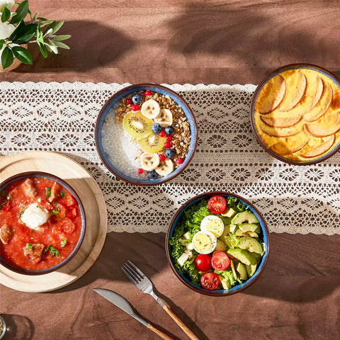 Sata green stoneware cereal bowls set of 4 with assorted meals styled on a wooden table with lace tablecloth farmhouse reactive glaze lipped edge artisan finish
