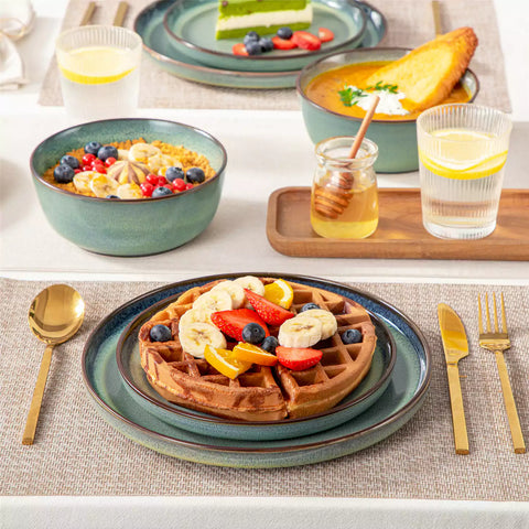 Sata green stoneware 12 piece dinnerware set with dinner plates salad plates and cereal bowls styled with gold cutlery on textured surface farmhouse reactive glaze lipped edge service for 4