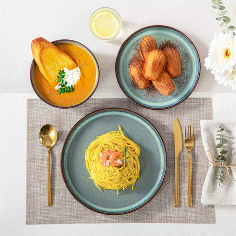 Sata green stoneware 12 piece dinnerware set with dinner plates salad plates and cereal bowls styled with gold cutlery on textured surface farmhouse reactive glaze lipped edge service for 4