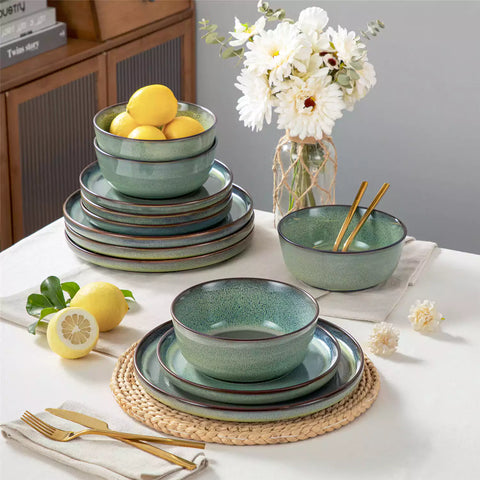 Sata green stoneware 12 piece dinnerware set with dinner plates salad plates and cereal bowls styled with gold cutlery on textured surface farmhouse reactive glaze lipped edge service for 4