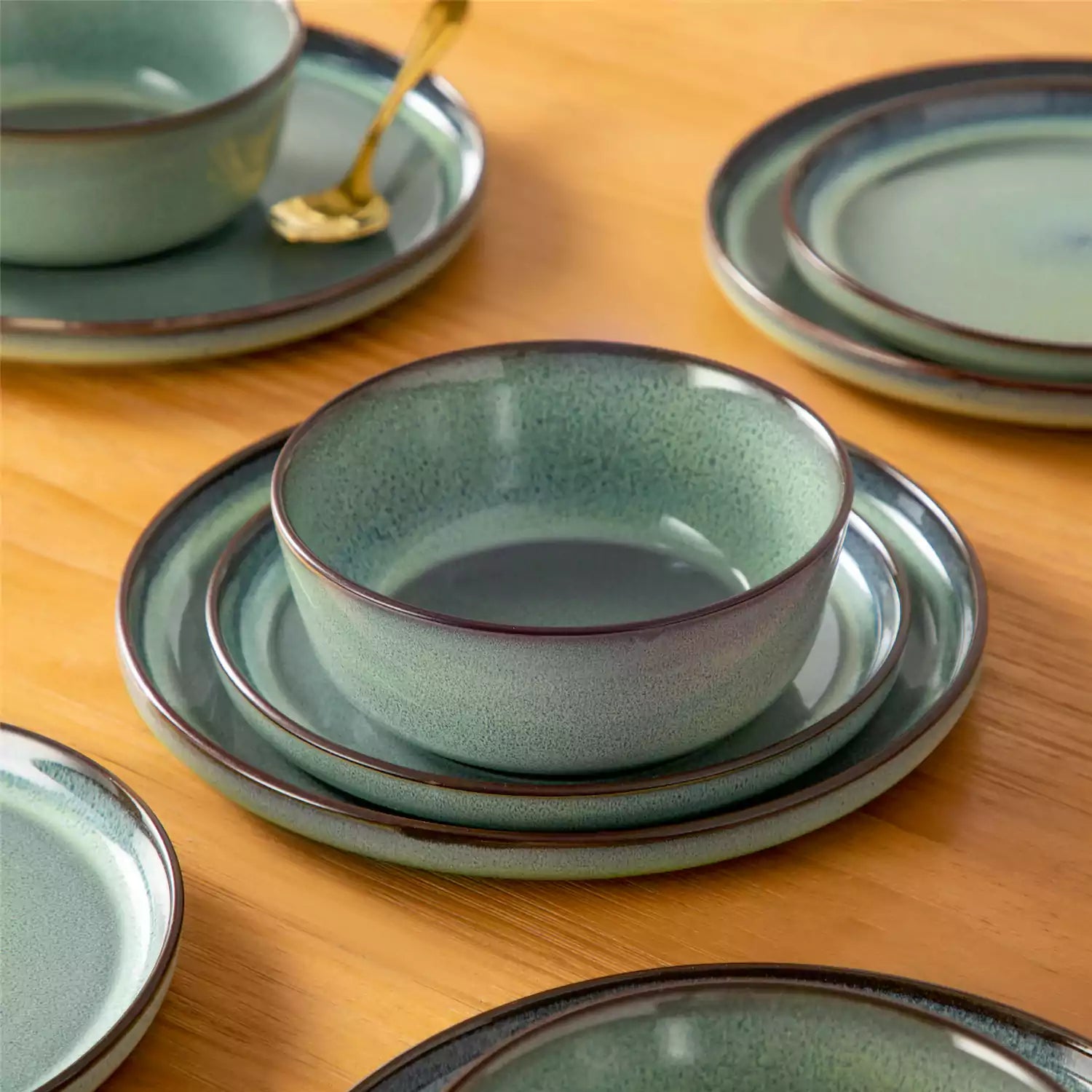 Sata green stoneware 18 piece dinnerware set with dinner plates salad plates and cereal bowls styled on a wooden table with diverse meal setup farmhouse reactive glaze lipped edge service for 6