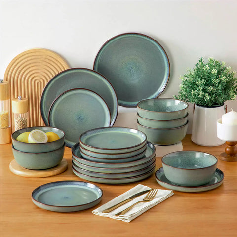 Sata green stoneware 18 piece dinnerware set with dinner plates salad plates and cereal bowls styled on a wooden table with diverse meal setup farmhouse reactive glaze lipped edge service for 6