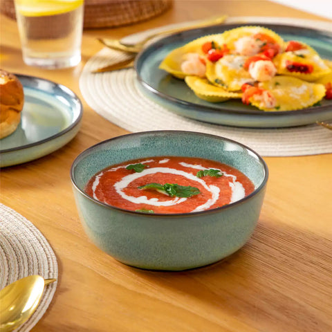 Sata green stoneware 18 piece dinnerware set with dinner plates salad plates and cereal bowls styled on a wooden table with diverse meal setup farmhouse reactive glaze lipped edge service for 6